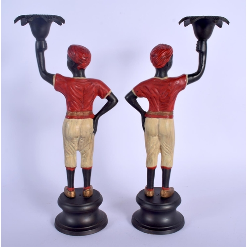 345 - A PAIR OF CONTEMPORARY COLD PAINTED BRONZE CANDLESTICKS modelled upon circular bases. 26.5 cm high.