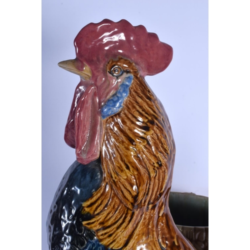 349 - A LARGE 19TH CENTURY CONTINENTAL MAJOLICA FIGURE OF A ROAMING COCK modelled upon a naturalistic base... 