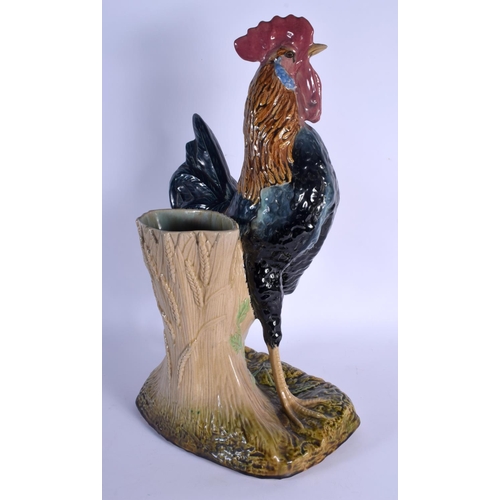 349 - A LARGE 19TH CENTURY CONTINENTAL MAJOLICA FIGURE OF A ROAMING COCK modelled upon a naturalistic base... 