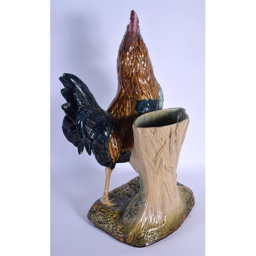 349 - A LARGE 19TH CENTURY CONTINENTAL MAJOLICA FIGURE OF A ROAMING COCK modelled upon a naturalistic base... 