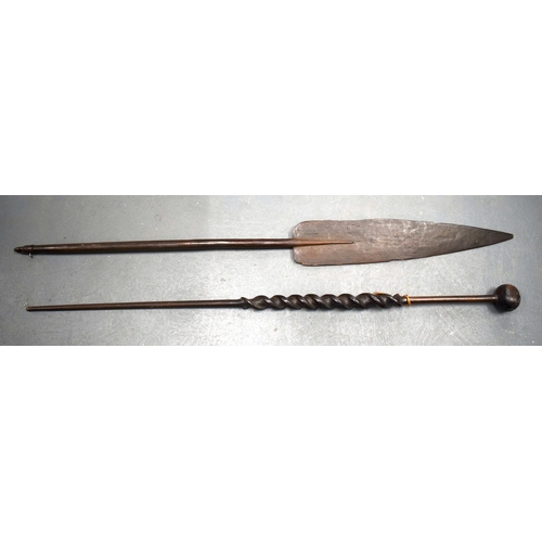 354 - A 19TH CENTURY AFRICAN TRIBAL CARVED WOOD PADDLE together with another similar. 155 cm long. (2)