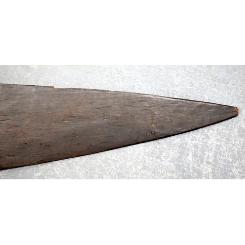 354 - A 19TH CENTURY AFRICAN TRIBAL CARVED WOOD PADDLE together with another similar. 155 cm long. (2)