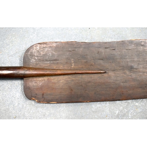 354 - A 19TH CENTURY AFRICAN TRIBAL CARVED WOOD PADDLE together with another similar. 155 cm long. (2)