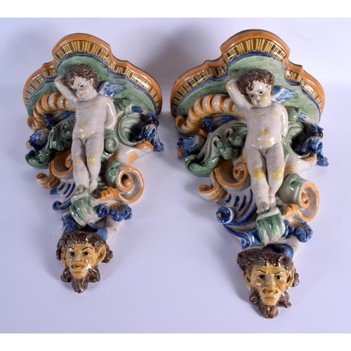 36 - A LARGE PAIR OF 19TH CENTURY ITALIAN MAJOLICA POTTERY WALL BRACKETS formed with figures over mask he... 