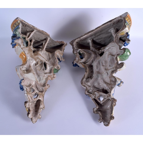 36 - A LARGE PAIR OF 19TH CENTURY ITALIAN MAJOLICA POTTERY WALL BRACKETS formed with figures over mask he... 