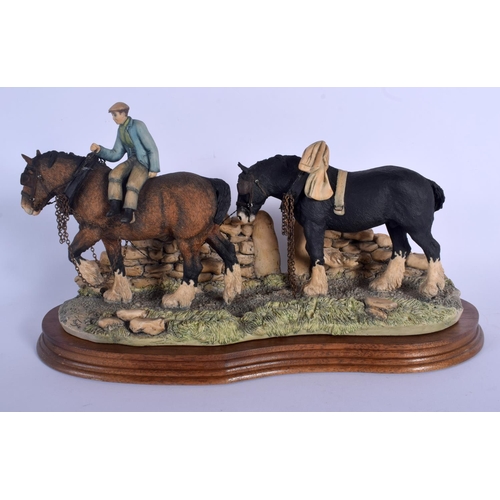 363 - A BORDER FINE ARTS FIGURE OF A SHIRE HORSES modelled with an attendant. 34 cm x 20 cm.