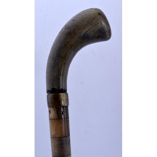 394 - A 19TH CENTURY CONTINENTAL FULL LENGTH RHINOCEROS AND BUFFALO HORN WALKING CANE. 88 cm long.