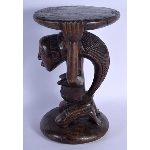 402 - A LARGE AFRICAN TRIBAL CARVED WOOD FERTILITY STOOL modelled upon a circular base. 43 cm x 23 cm.