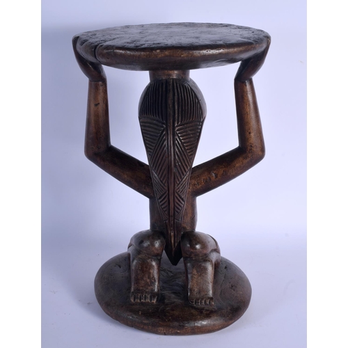 402 - A LARGE AFRICAN TRIBAL CARVED WOOD FERTILITY STOOL modelled upon a circular base. 43 cm x 23 cm.