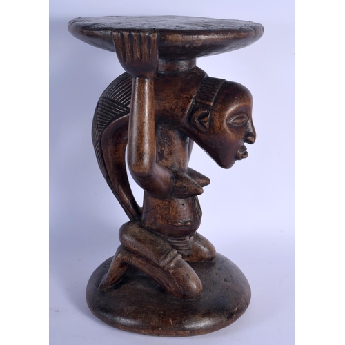 402 - A LARGE AFRICAN TRIBAL CARVED WOOD FERTILITY STOOL modelled upon a circular base. 43 cm x 23 cm.