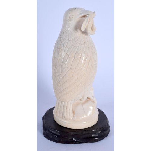 408 - A 19TH CENTURY EUROPEAN CARVED IVORY FIGURE OF A BIRD modelled holding an insect within its mouth. 1... 