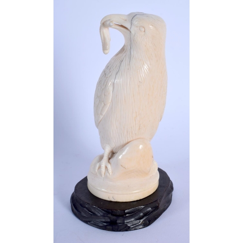 408 - A 19TH CENTURY EUROPEAN CARVED IVORY FIGURE OF A BIRD modelled holding an insect within its mouth. 1... 