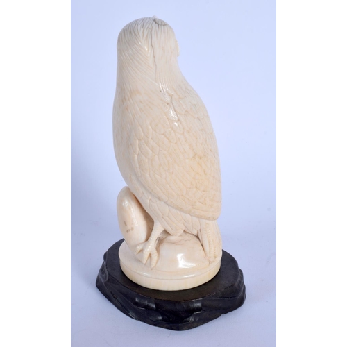 408 - A 19TH CENTURY EUROPEAN CARVED IVORY FIGURE OF A BIRD modelled holding an insect within its mouth. 1... 