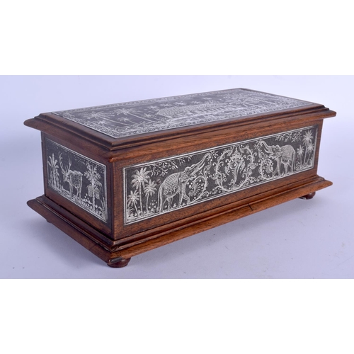 410 - A FINE 19TH CENTURY ANGLO INDIAN SILVERED STEEL AND HARDWOOD CASKET decorated with elephants and lan... 