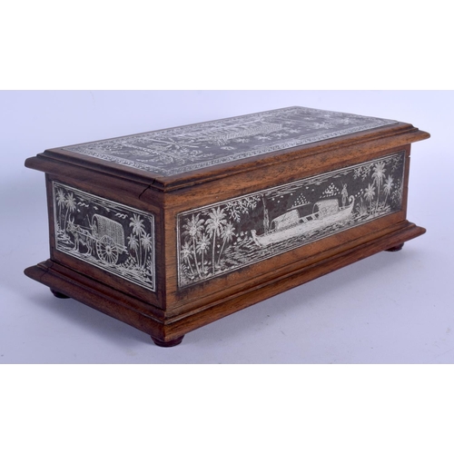 410 - A FINE 19TH CENTURY ANGLO INDIAN SILVERED STEEL AND HARDWOOD CASKET decorated with elephants and lan... 