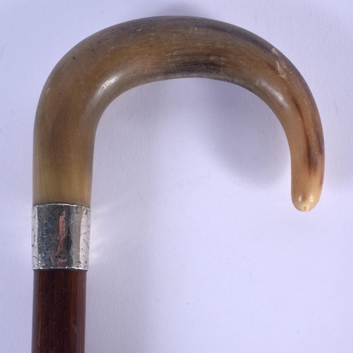 417 - A 19TH CENTURY CONTINENTAL CARVED RHINOCEROS HORN WALKING CANE with silver mounts. 84 cm long.