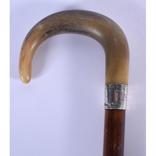 417 - A 19TH CENTURY CONTINENTAL CARVED RHINOCEROS HORN WALKING CANE with silver mounts. 84 cm long.