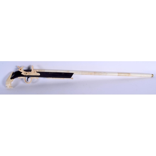 436 - A LARGE CONTINENTAL CARVED BONE RIFLE with lion mask head terminal. 90 cm long.