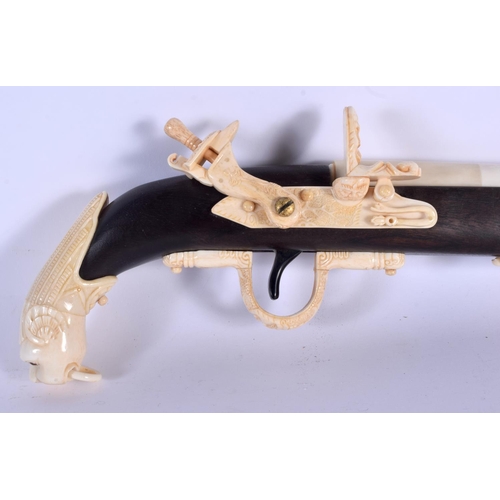 436 - A LARGE CONTINENTAL CARVED BONE RIFLE with lion mask head terminal. 90 cm long.