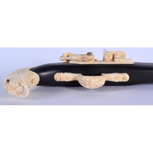 436 - A LARGE CONTINENTAL CARVED BONE RIFLE with lion mask head terminal. 90 cm long.