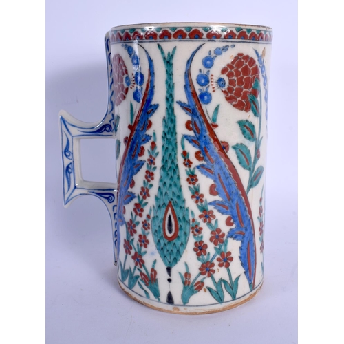 438 - A CONTINENTAL IZNIK TYPE FAIENCE POTTERY CARAFE JUG painted with stylised flowers and vines. 21 cm h... 