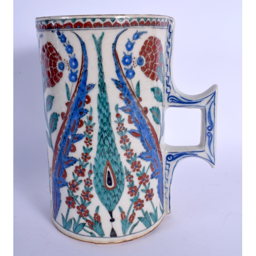 438 - A CONTINENTAL IZNIK TYPE FAIENCE POTTERY CARAFE JUG painted with stylised flowers and vines. 21 cm h... 