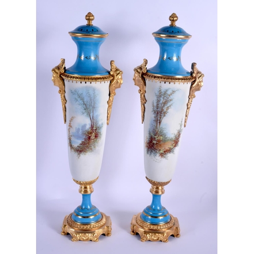 46 - A LARGE PAIR OF CONTINENTAL SEVRES STYLE PORCELAIN VASES AND COVERS painted with figures within land... 