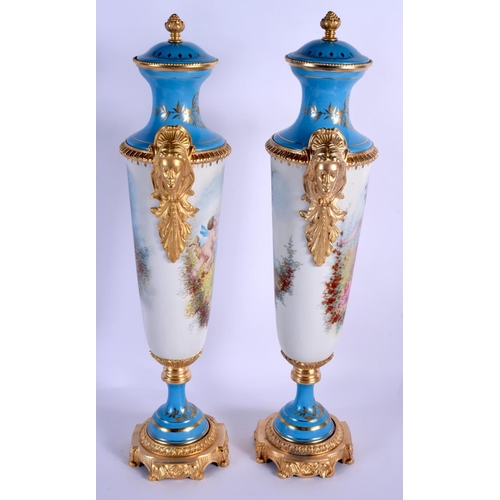 46 - A LARGE PAIR OF CONTINENTAL SEVRES STYLE PORCELAIN VASES AND COVERS painted with figures within land... 