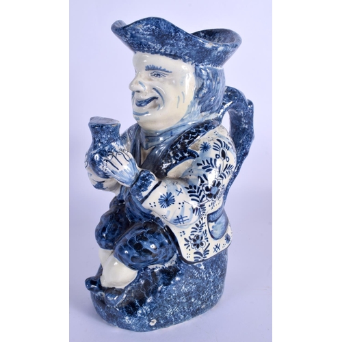 63 - AN ANTIQUE DUTCH BLUE AND WHITE DELFT POTTERY TOBY JUG modelled as a male holding an ale jug. 27 cm ... 