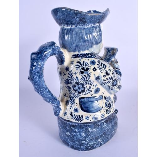 63 - AN ANTIQUE DUTCH BLUE AND WHITE DELFT POTTERY TOBY JUG modelled as a male holding an ale jug. 27 cm ... 