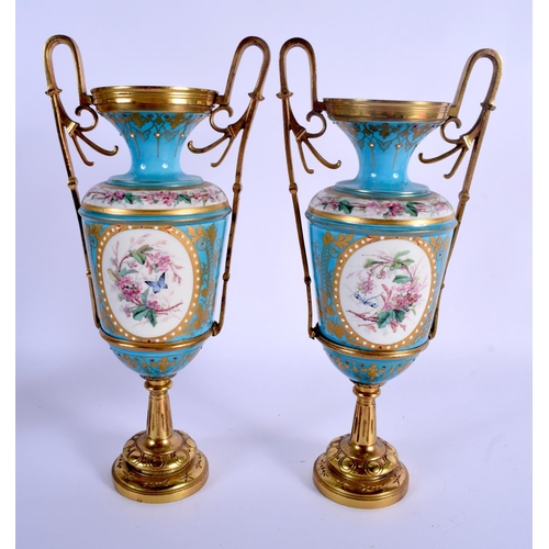 65 - A PAIR OF 19TH CENTURY FRENCH SEVRES PORCELAIN VASES painted and jewelled with putti in various purs... 