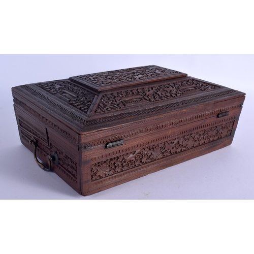 664 - A 19TH CENTURY ANGLO INDIAN CARVED SANDALWOOD WRITING BOX AND COVER with fitted slope. 32 cm x 22 cm... 