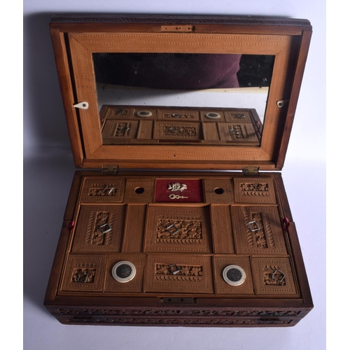 664 - A 19TH CENTURY ANGLO INDIAN CARVED SANDALWOOD WRITING BOX AND COVER with fitted slope. 32 cm x 22 cm... 