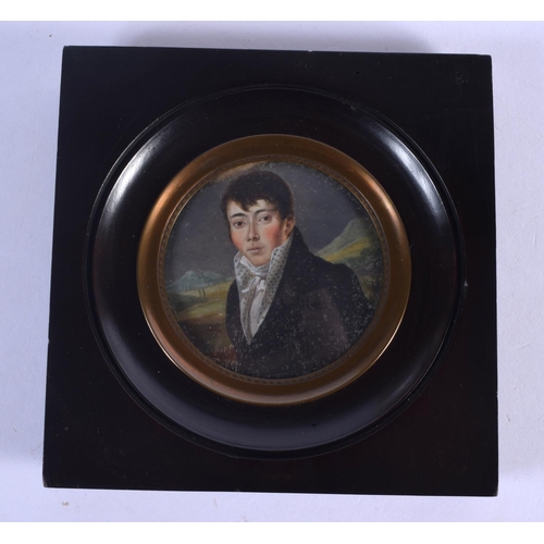 669 - English School (19th Century) Ivory miniature, handsome male in blue. Image 6.5 cm wide.