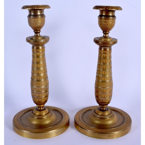 672 - A PAIR OF 19TH CENTURY FRENCH EMPIRE STYLE BRONZE CANDLESTICKS. 24 cm high.