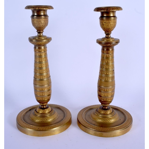 672 - A PAIR OF 19TH CENTURY FRENCH EMPIRE STYLE BRONZE CANDLESTICKS. 24 cm high.