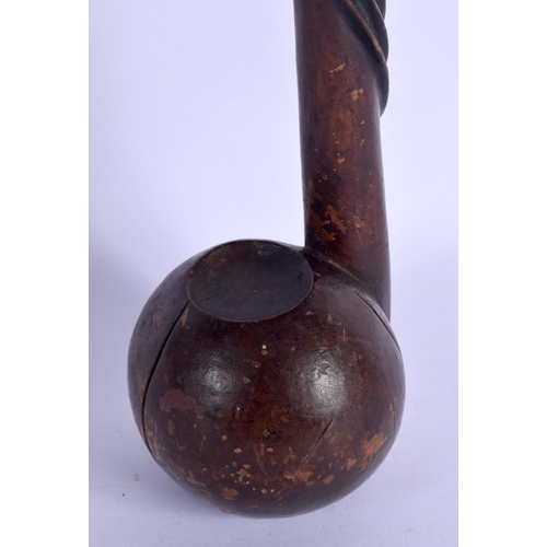 678 - AN UNUSUAL POLYNESIAN CARVED TRIBAL HARDWOOD CLUB of pipe like form with entwined shaft. 52 cm long.