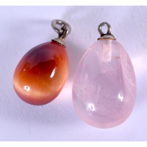 1004 - TWO VINTAGE HARDSTONE EASTER EGG PENDANTS. 1.25 cm x 1 cm. (2)