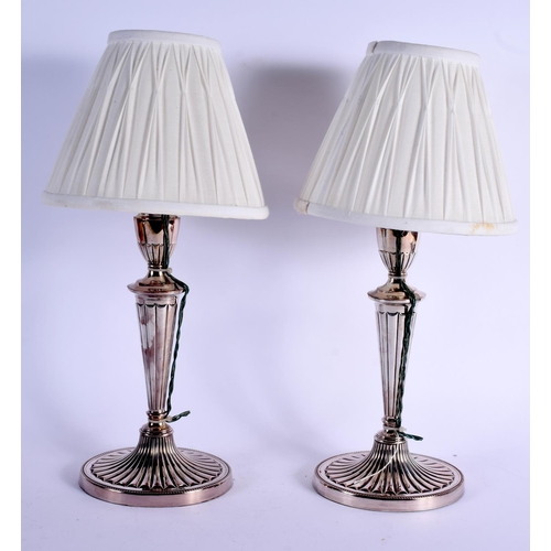 1011 - A PAIR OF ANTIQUE ENGLISH SILVER PLATED CANDLESTICKS converted to lamps. Sticks 31 cm high.