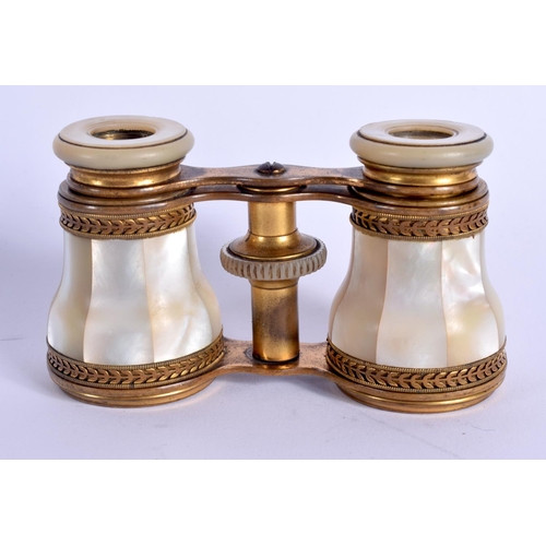 1013 - A PAIR OF ANTIQUE BRASS BINOCULARS. 9 cm x 7 cm.