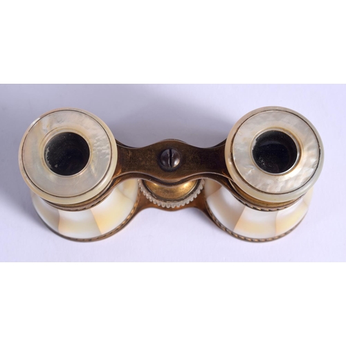 1013 - A PAIR OF ANTIQUE BRASS BINOCULARS. 9 cm x 7 cm.