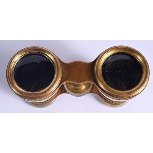 1013 - A PAIR OF ANTIQUE BRASS BINOCULARS. 9 cm x 7 cm.