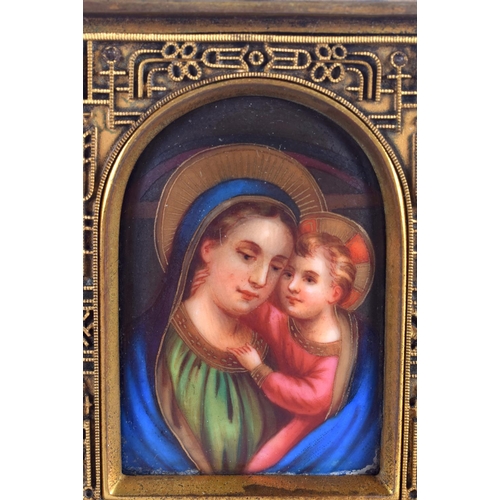 1023 - A 19TH CENTURY EUROPEAN BRONZE AND PORCELAIN ICON painted with a Madonna and child. 11 cm x 13 cm.