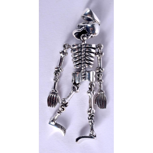 1075 - A SILVER SKELETON. 14 grams. 6 cm x 2 cm.