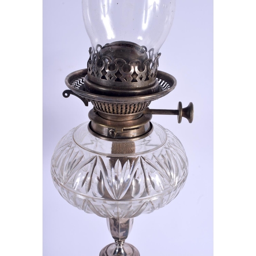 1093 - AN ANTIQUE SILVER PLATED OIL LAMP. 45 cm high not inc funnel.