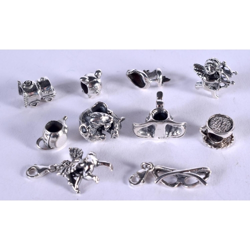 1109 - TEN SILVER CHARMS. 30 grams. 1 cm x 1 cm. (6)