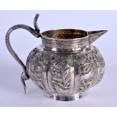 1123 - AN ANTIQUE INDIAN SILVER CREAM JUG. 101 grams. 7.5 cm x 10 cm.