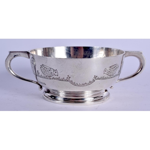 1126 - AN ART DECO TWIN HANDLED SILVER FEEDING BOWL decorated with fowl. Birmingham 1942. 264 grams. 5 cm x... 