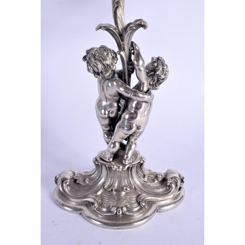 1157 - A LOVELY PAIR OF CONTINENTAL SILVER CANDLEABRA modelled two cherubs holding aloft floral capped scon... 