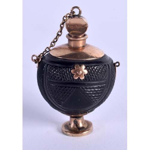 1168 - AN ANTIQUE GOLD MOUNTED BOG OAK SCENT BOTTLE. 9 grams. 4 cm high.